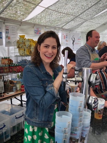 Victoria Atkins MP pulling pints in the Dad's Army bar at the Woodhall Forties Festival